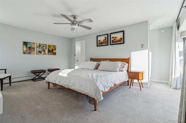 carpeted bedroom with baseboard heating and ceiling fan