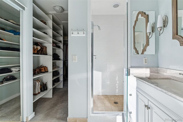 bathroom featuring vanity and a shower with shower door