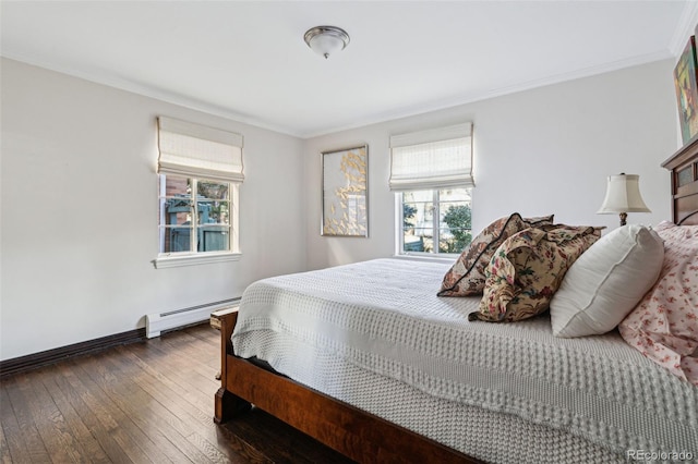 bedroom featuring dark hardwood / wood-style flooring, baseboard heating, and ornamental molding