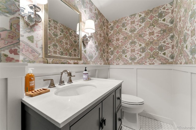 bathroom with toilet, tile patterned floors, and vanity