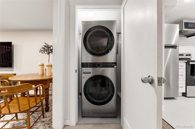 washroom featuring stacked washer / drying machine