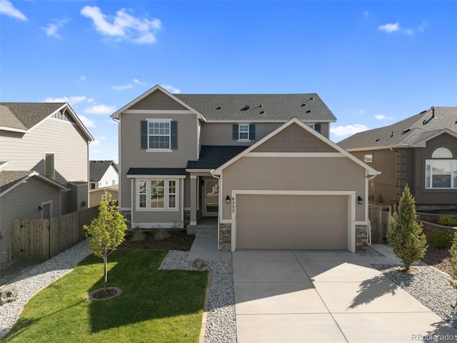 8235 Ryegate Way, Colorado Springs, CO 80908 - view of front of property featuring an attached garage, driveway, stone siding, and roof with shingles