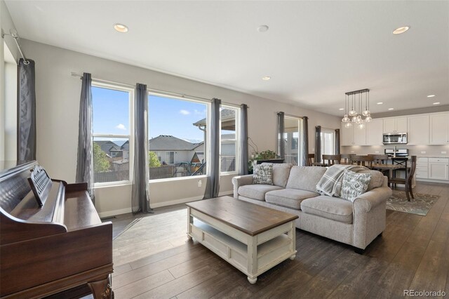 8235 Ryegate Way, Colorado Springs, CO 80908 - living area with dark wood-style floors, a chandelier, and recessed lighting