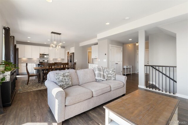 8235 Ryegate Way, Colorado Springs, CO 80908 - living area featuring dark wood-type flooring, recessed lighting, baseboards, and a chandelier