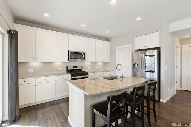 8235 Ryegate Way, Colorado Springs, CO 80908 - kitchen featuring stainless steel appliances, a sink, dark wood-type flooring, white cabinets, and recessed lighting