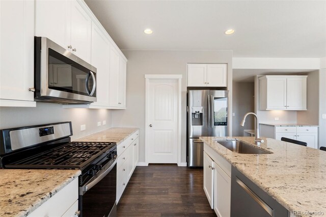 8235 Ryegate Way, Colorado Springs, CO 80908 - kitchen with stainless steel appliances, a sink, dark wood-style flooring, white cabinets, and recessed lighting