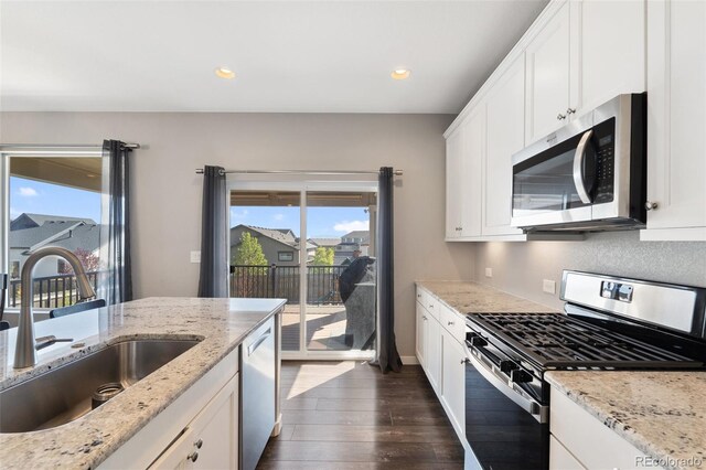 8235 Ryegate Way, Colorado Springs, CO 80908 - kitchen with appliances with stainless steel finishes, a sink, dark wood-style floors, white cabinetry, and recessed lighting
