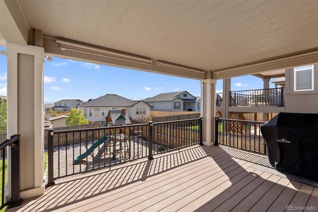 8235 Ryegate Way, Colorado Springs, CO 80908 - wooden terrace with a playground, a residential view, and a fenced backyard