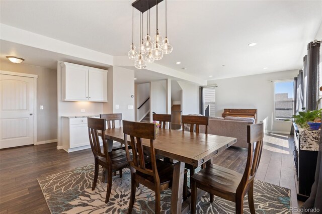 8235 Ryegate Way, Colorado Springs, CO 80908 - dining area featuring dark wood-style flooring, stairs, baseboards, and recessed lighting