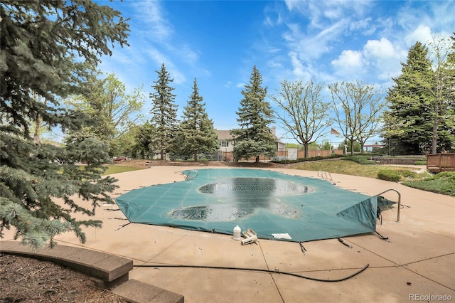 view of pool with a patio and fence