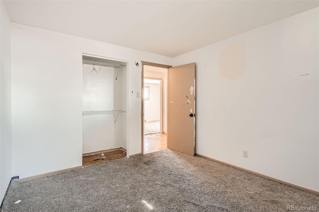 unfurnished bedroom with a closet, carpet, and baseboards