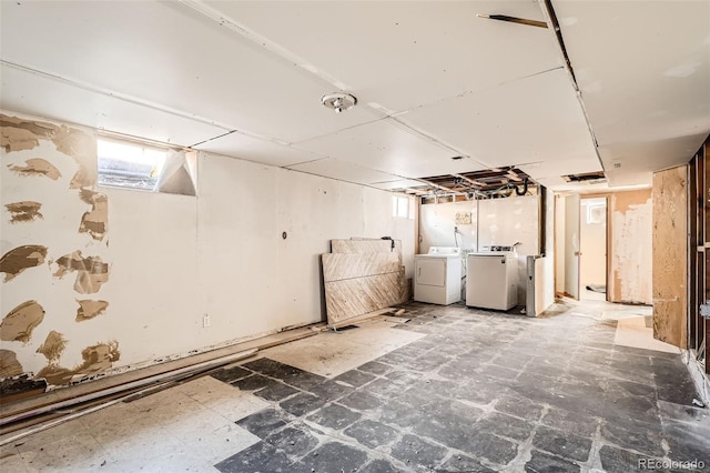 basement with tile patterned floors and washer and dryer