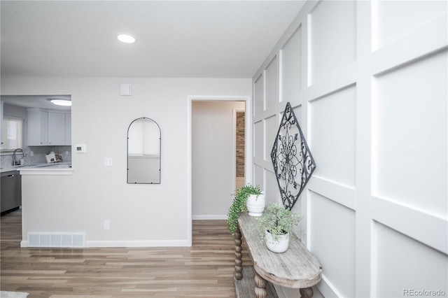 hall with light hardwood / wood-style floors