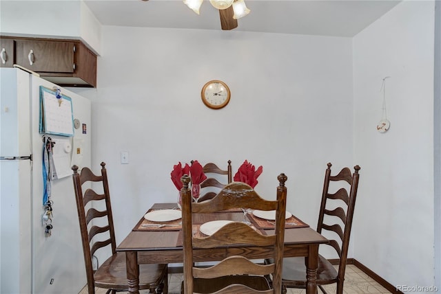 dining space featuring light tile patterned floors and ceiling fan