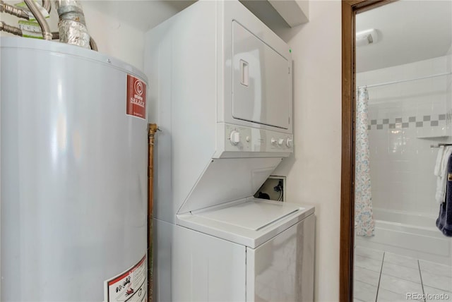 laundry room featuring water heater, stacked washer and dryer, and light tile patterned floors