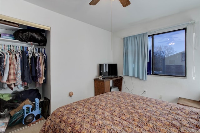 carpeted bedroom with ceiling fan and a closet