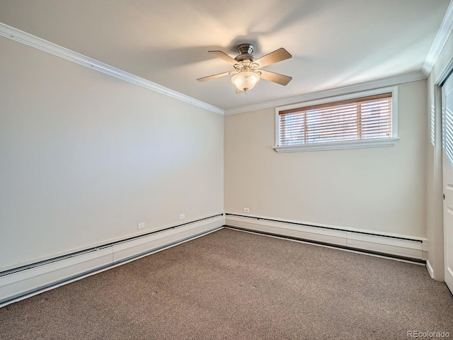 spare room featuring a baseboard heating unit, carpet floors, and crown molding