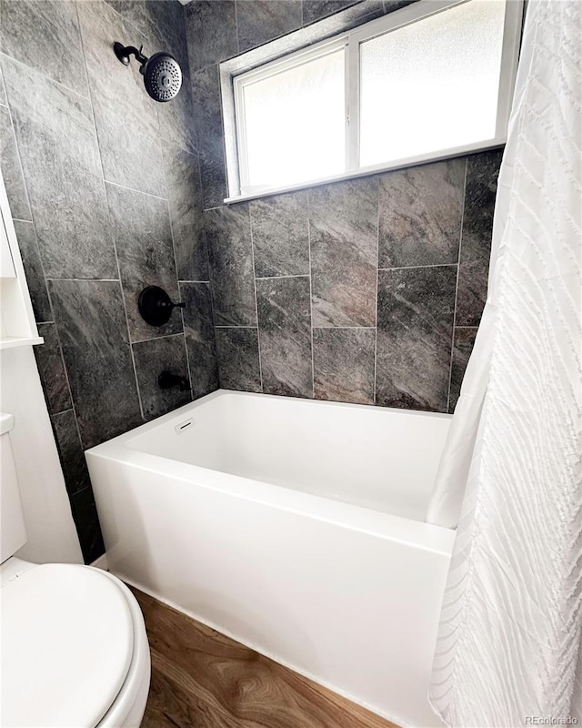full bathroom with toilet and shower / bath combo with shower curtain