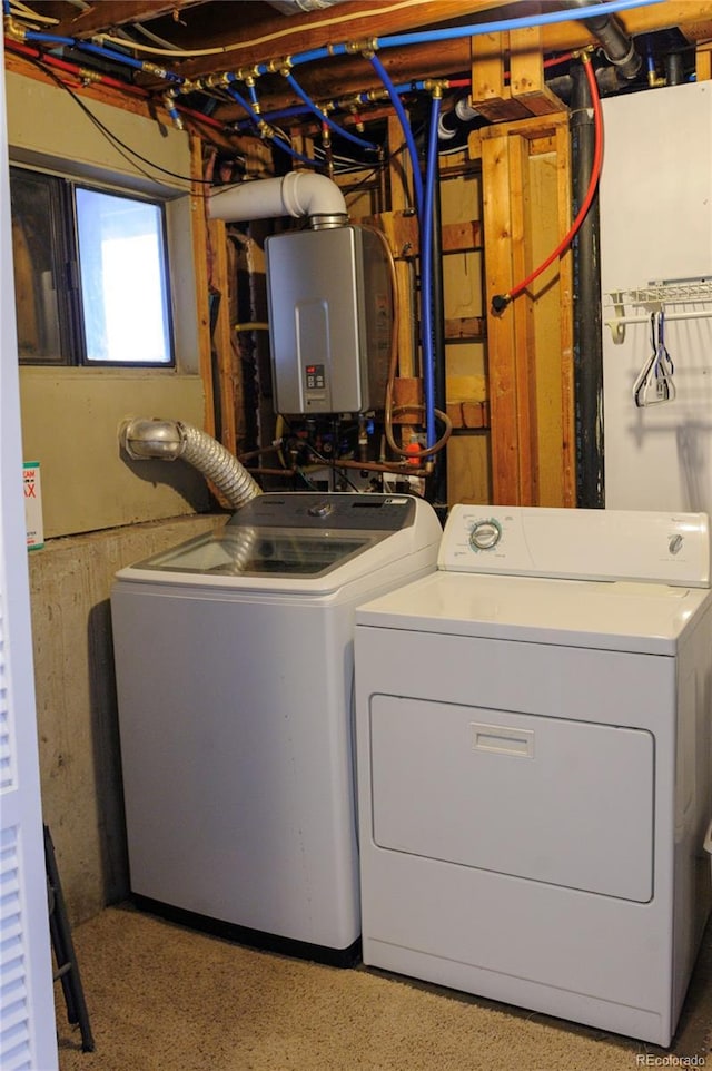 washroom with tankless water heater, laundry area, and independent washer and dryer