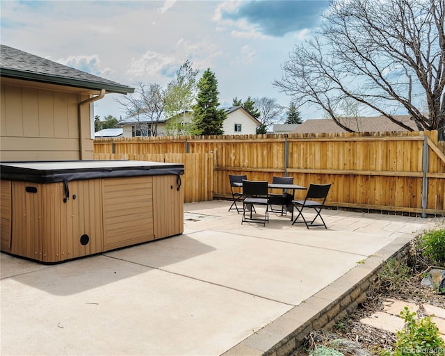 view of patio / terrace featuring a hot tub and a fenced backyard