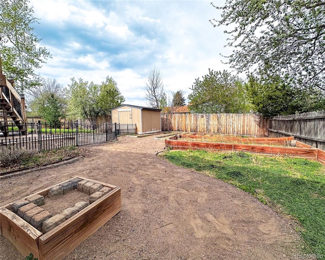 view of yard with a fenced backyard, a garden, a storage shed, and an outbuilding