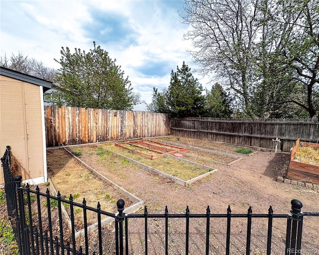 view of yard featuring a fenced backyard and a vegetable garden