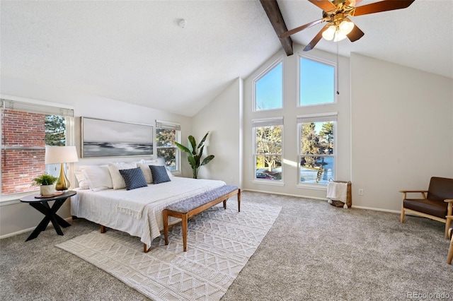 bedroom with multiple windows, ceiling fan, and beamed ceiling