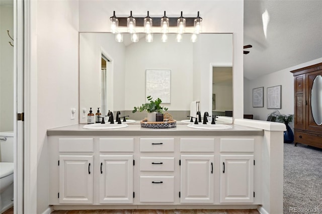 bathroom with vanity, ceiling fan, toilet, and a textured ceiling