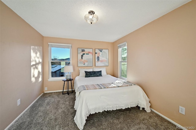 carpeted bedroom featuring a textured ceiling