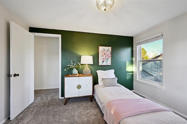 carpeted bedroom featuring a textured ceiling