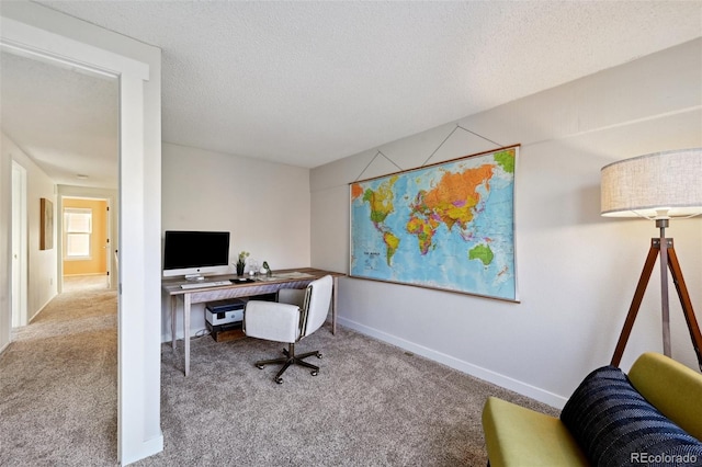 carpeted home office with a textured ceiling