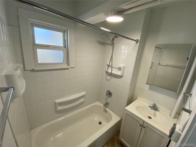 bathroom featuring vanity and tiled shower / bath