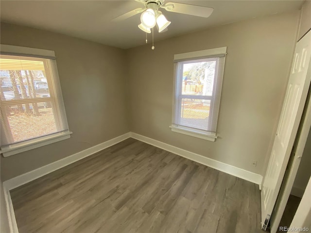 spare room featuring ceiling fan and dark hardwood / wood-style flooring