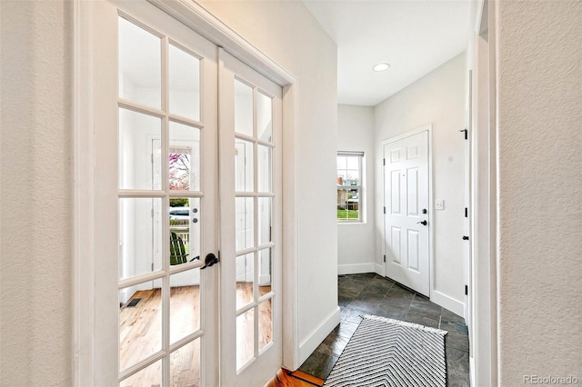 4530 Quitman St, Denver, CO 80212 - doorway to outside featuring stone tile floors, a textured wall, french doors, and baseboards