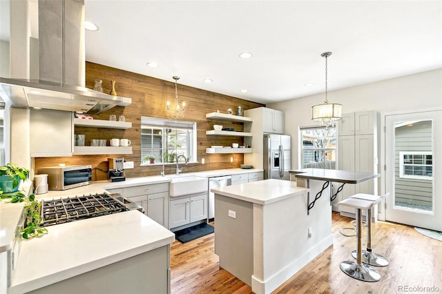 4530 Quitman St, Denver, CO 80212 - kitchen with stainless steel appliances, a center island, island exhaust hood, a sink, and open shelves