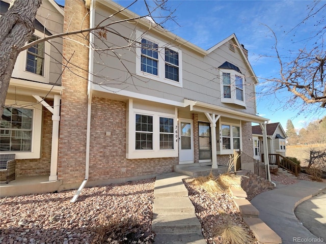 townhome / multi-family property featuring brick siding