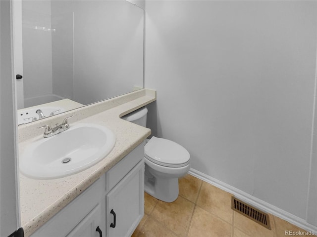 bathroom featuring visible vents, baseboards, toilet, tile patterned flooring, and vanity