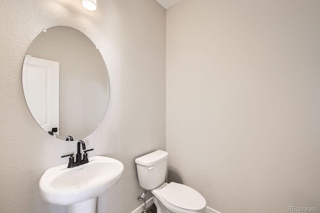 bathroom featuring sink and toilet