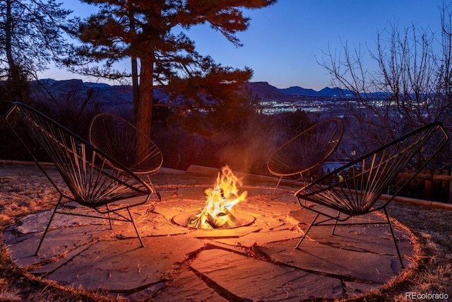 view of patio featuring a mountain view and an outdoor fire pit