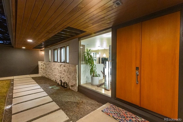 interior space with elevator, visible vents, and wood ceiling