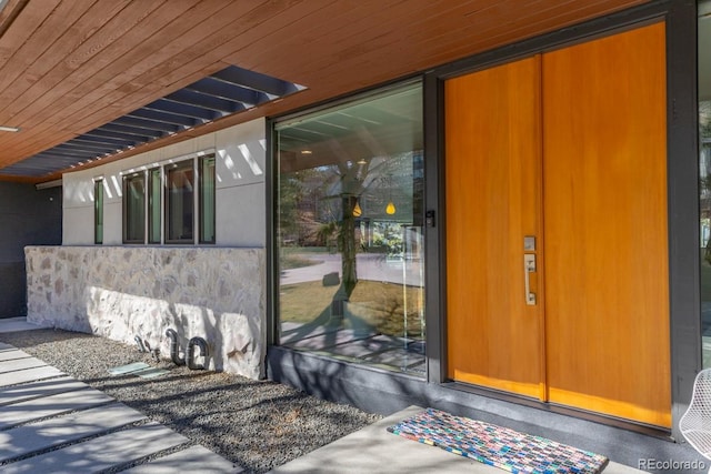 entrance to property with stone siding