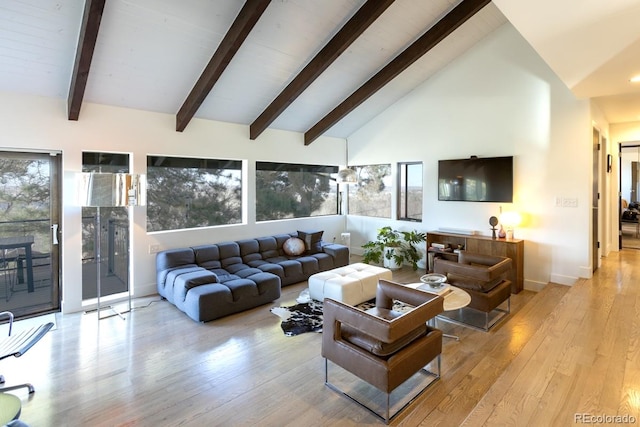 living area featuring beam ceiling, wood finished floors, and high vaulted ceiling