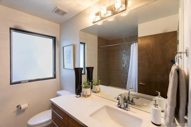 bathroom with visible vents, toilet, vanity, and a shower with shower curtain