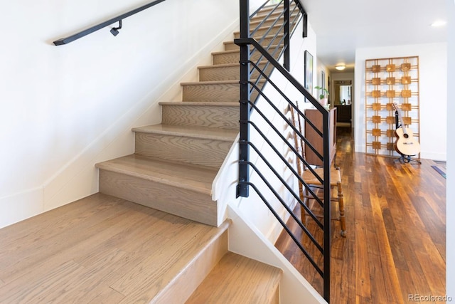 stairs with wood finished floors