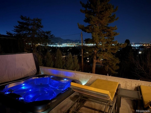 pool at night with hot tub deck surround