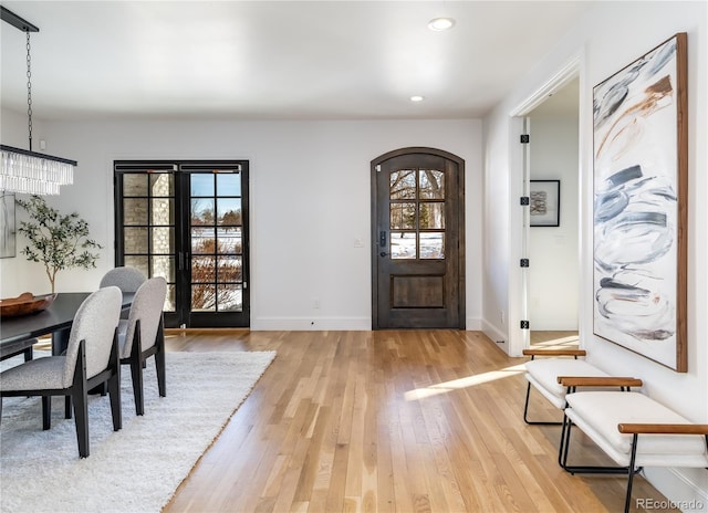 foyer featuring a notable chandelier and light wood-type flooring