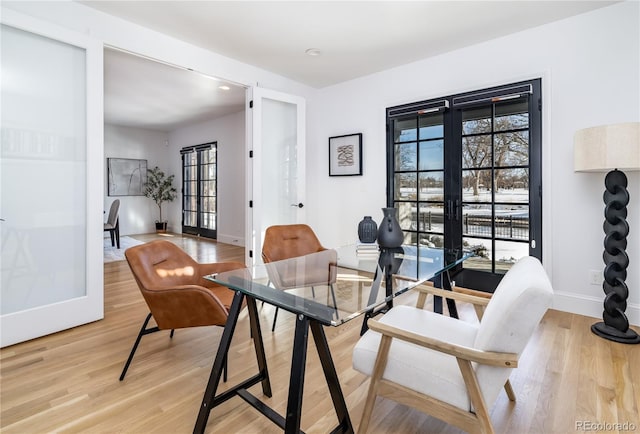 dining area with french doors and wood-type flooring