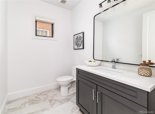 bathroom featuring vanity and toilet