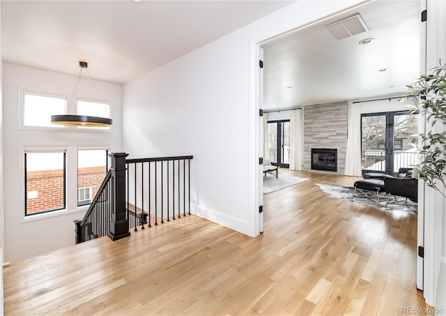 living room featuring hardwood / wood-style flooring, french doors, and a fireplace