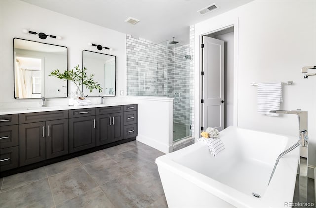 bathroom with vanity and shower with separate bathtub